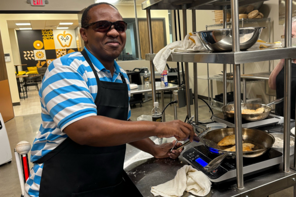 Johnson Riungu, Envision employee, cooking in the kitchen at NICHE.