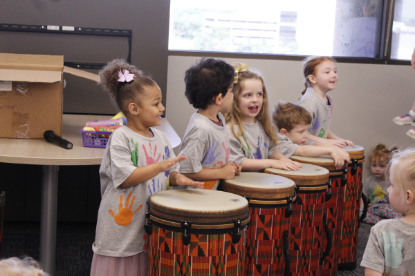 Kids playing on the drums.