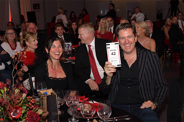 Two people sitting at a table laughing at Gala.