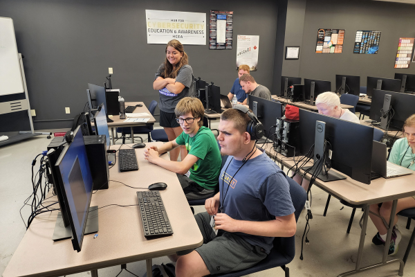 Students who are blind or visually impaired in a cybersecurity room working on computer development projects