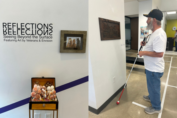 A photo of a person holding their cane admiring a piece of artwork on the wall.