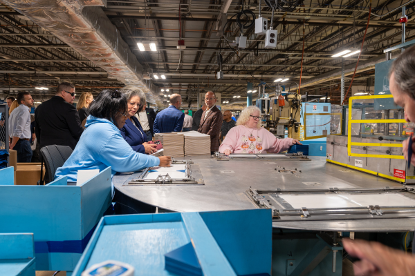 People touring the manufacturing facility.