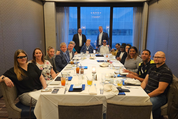 Envision employees of the year and leadership at a dinner table.