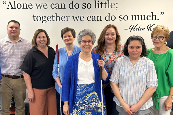 The contact center team smiles for a photo.