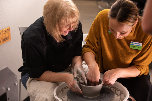 A photo of a blind woman making pottery.