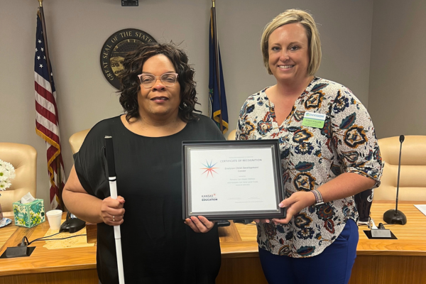 Stacy and Teresa standing with their award.