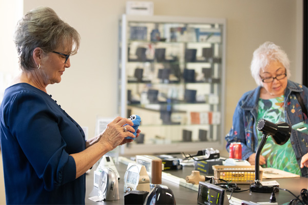 Woman wearing glasses looks at the products in the Envision Everyday Store