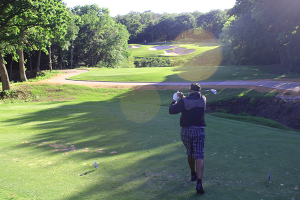 Too Tall Jones takes a swing on the green at the Cowboys Golf Club.