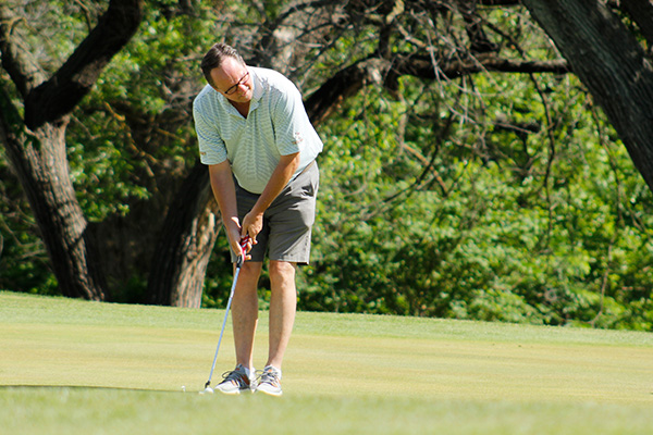 Golfer Gregg Marshall takes a shot on the green.