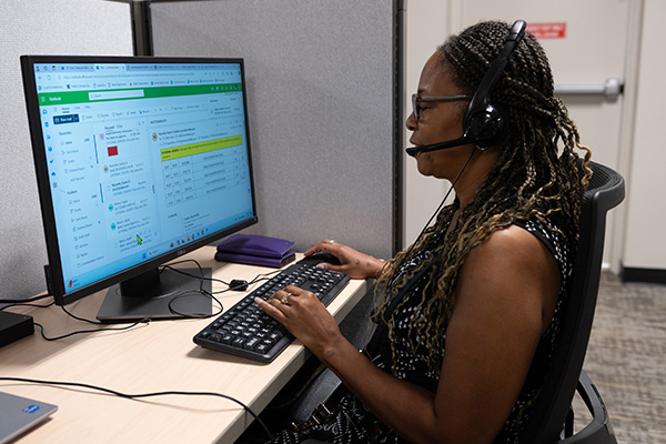 Woman who is low vision works at the Call Center at Envision Dallas