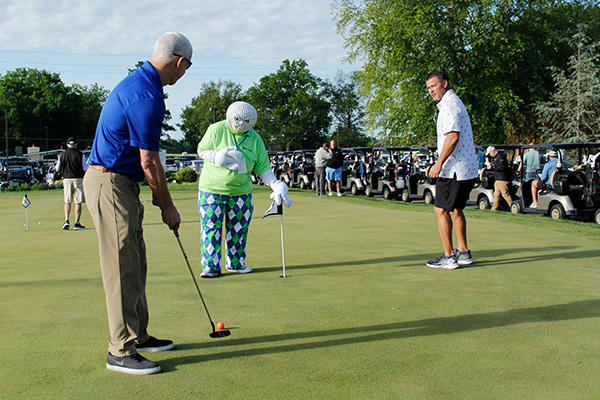 Golfers at the Wichita tournament try their putting skills.